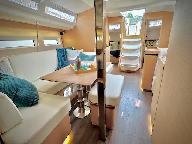 Slide: The Image of 2023 Jeanneau Sun Odyssey 440 interior, modern design with cozy seating and natural light. - 33