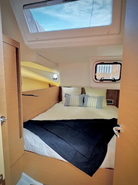 Slide: The Image of 2023 Jeanneau Sun Odyssey 440 cabin interior with cozy bed and skylight. - 39