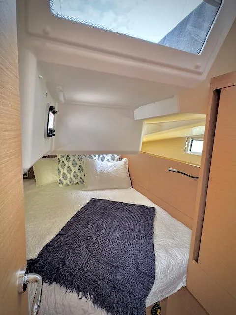 Slide: The Image of Cozy cabin interior of 2023 Jeanneau Sun Odyssey 440 sailboat with skylight and bedding. - 40