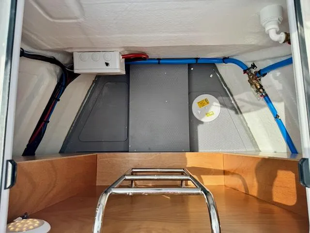 Slide: The Image of Interior view of 2023 Jeanneau Sun Odyssey 440 yacht, showcasing storage and plumbing. - 43