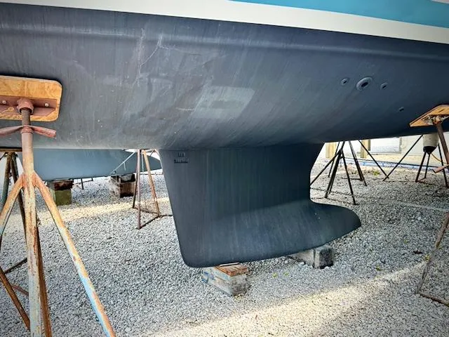 Slide: The Image of Jeanneau Sun Odyssey 440 keel, 2023 model, on stands in a boatyard. - 44