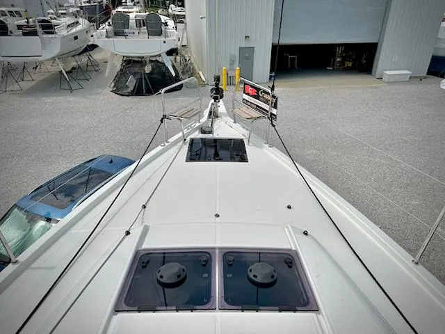 Slide: The Image of 2023 Jeanneau Sun Odyssey 440 yacht in a marina, viewed from the bow. - 6