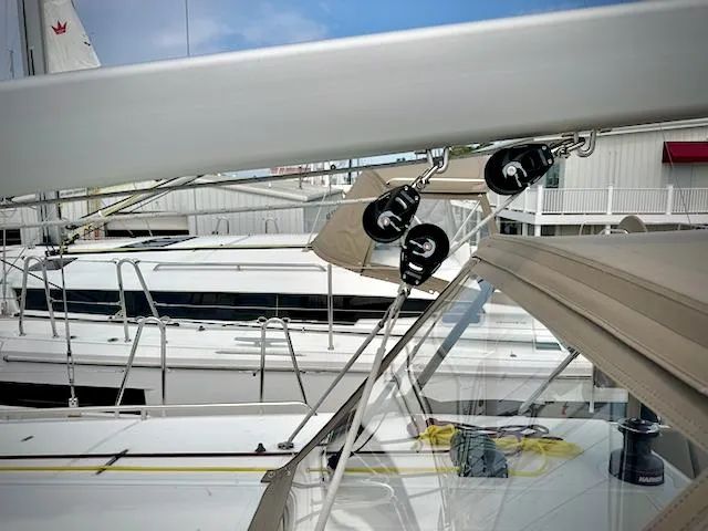 Slide: The Image of 2023 Jeanneau Sun Odyssey 440 sailboat with rigging details in marina. - 9