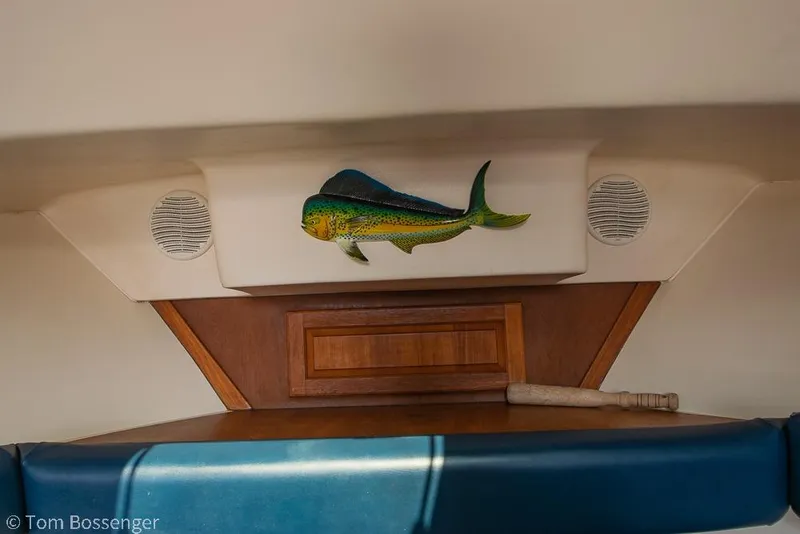Slide: The Image of 1999 Mainship Pilot 30 cabin interior with fish decor and wooden accents. - 19