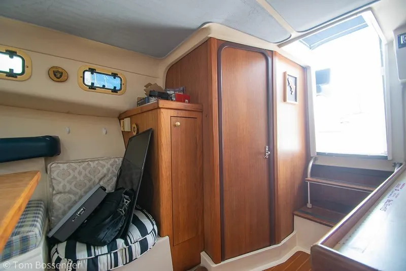 Slide: The Image of Interior of 1999 Mainship Pilot 30 boat with wooden cabinetry and seating area. - 20