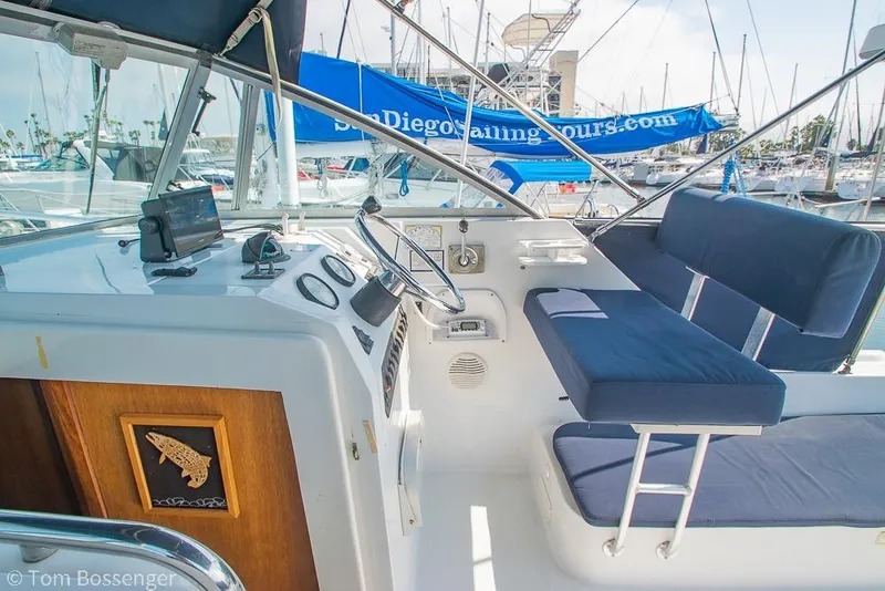 Slide: The Image of 1999 Mainship Pilot 30 boat cockpit with blue seating and navigation equipment. - 25