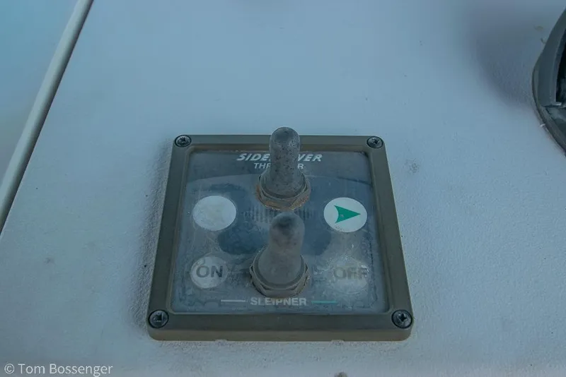 Slide: The Image of Control panel of a 1999 Mainship Pilot 30 boat with switches and indicators. - 27