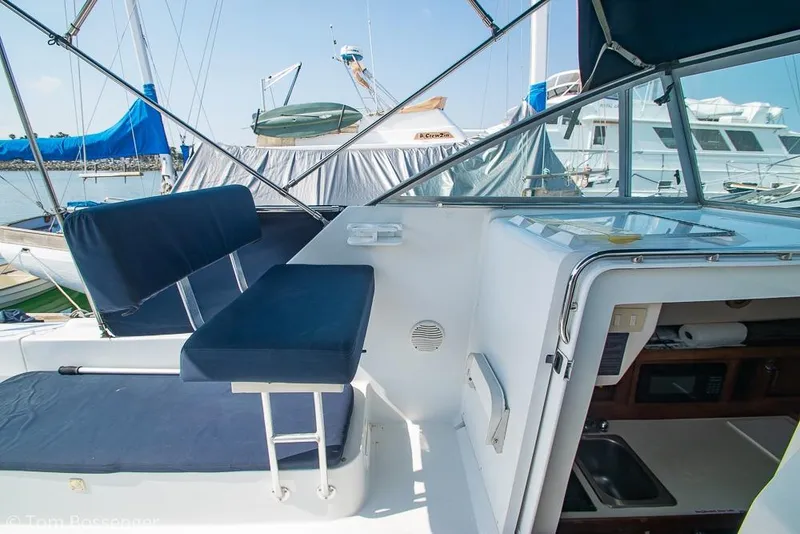 Slide: The Image of 1999 Mainship Pilot 30 boat interior with blue seating and cabin entrance. - 30