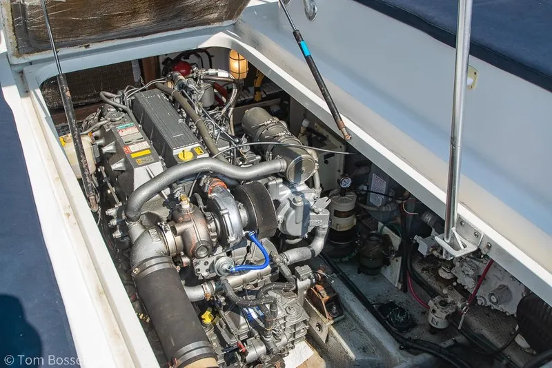 Slide: The Image of Engine compartment of a 1999 Mainship Pilot 30 boat, showcasing detailed mechanical components. - 37