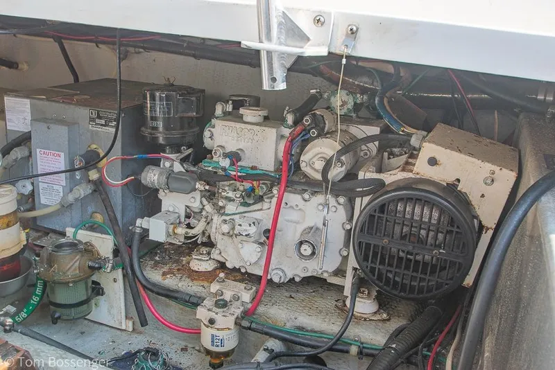 Slide: The Image of Engine compartment of a 1999 Mainship Pilot 30 boat, showing detailed mechanical components. - 39