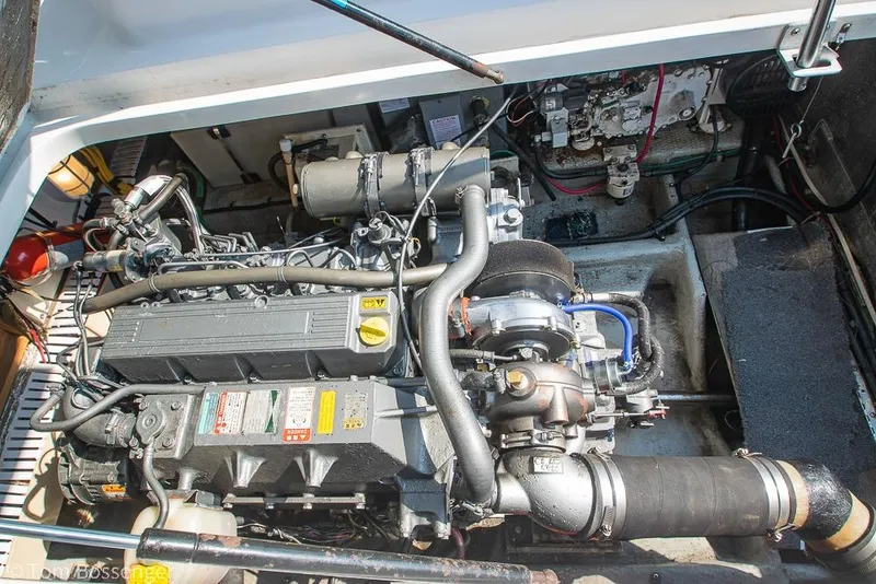 Slide: The Image of Engine compartment of a 1999 Mainship Pilot 30 boat, showcasing detailed mechanical components. - 40