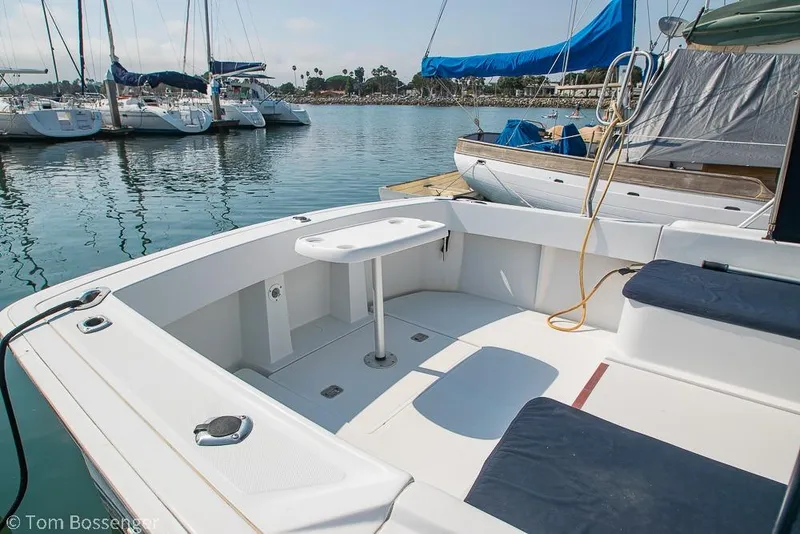 Slide: The Image of 1999 Mainship Pilot 30 boat interior at marina, featuring seating and table. - 9