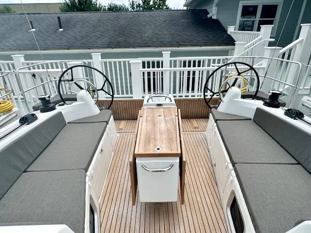 Slide: The Image of 2024 Jeanneau Sun Odyssey 410 yacht cockpit with dual steering wheels and teak flooring. - 12