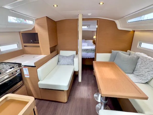 Slide: The Image of 2024 Jeanneau Sun Odyssey 410 interior with modern seating and dining area. - 18