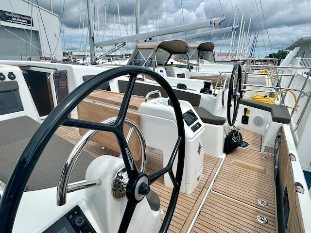 Slide: The Image of 2024 Jeanneau Sun Odyssey 410 yacht with dual steering wheels and teak deck. - 4
