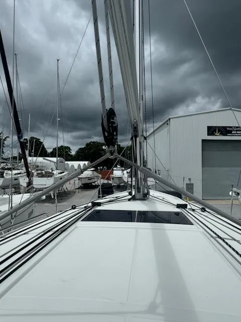 Slide: The Image of 2024 Jeanneau Sun Odyssey 410 sailboat docked under cloudy skies. - 7