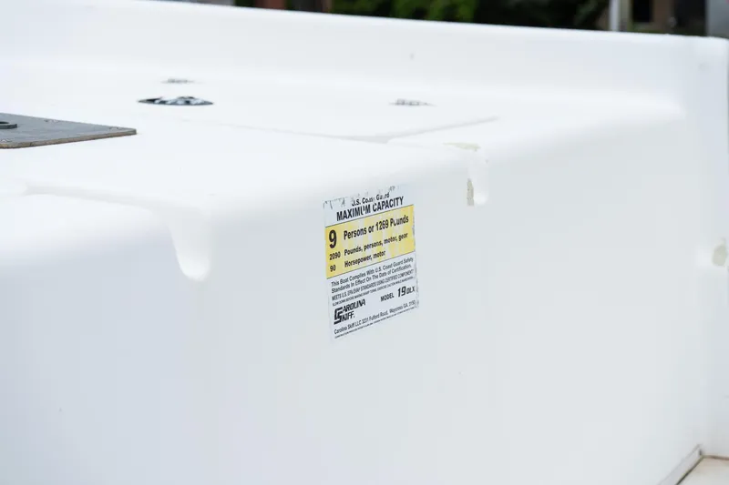 Slide: The Image of 2015 Carolina Skiff 1980 DLX boat capacity label, showing maximum weight and passenger limits. - 11