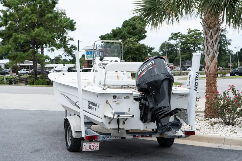Slide: The Image of 2015 Carolina Skiff 1980 DLX boat with Suzuki outboard motor on trailer. - 5