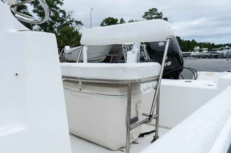 Slide: The Image of 2015 Carolina Skiff 1980 DLX boat with white seating and cooler storage. - 9