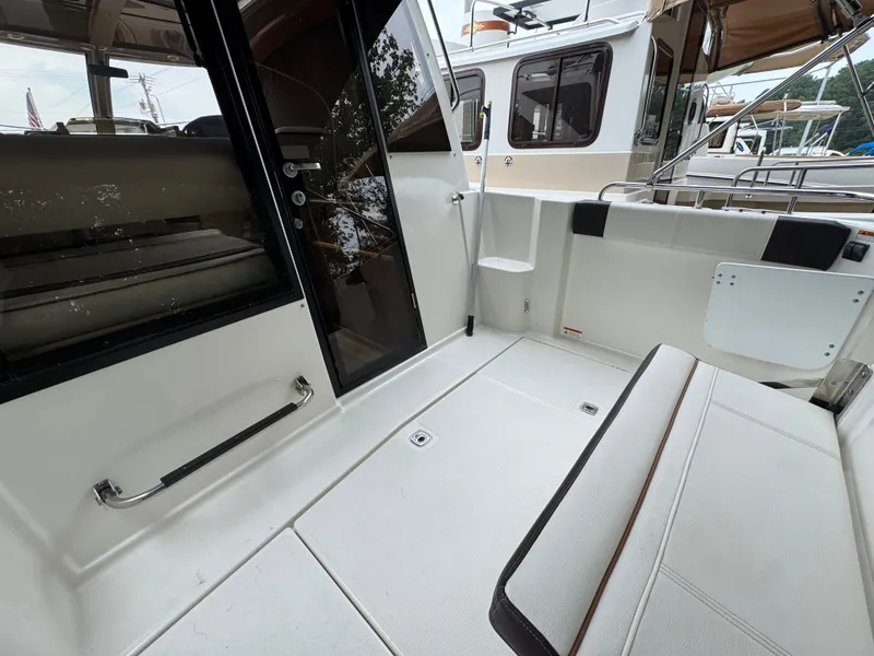 Slide: The Image of 2016 Cutwater C-24 boat interior with seating and door, showcasing modern design. - 11