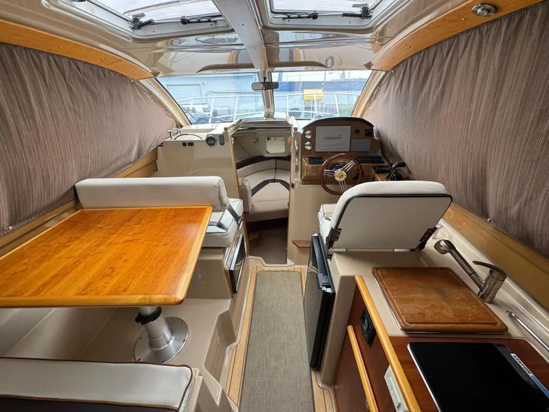 Slide: The Image of Interior of a 2016 Cutwater C-24 boat with seating, table, and navigation equipment. - 15