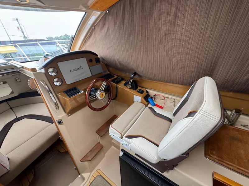 Slide: The Image of Interior of 2016 Cutwater C-24 boat with Garmin navigation system and captain's chair. - 21