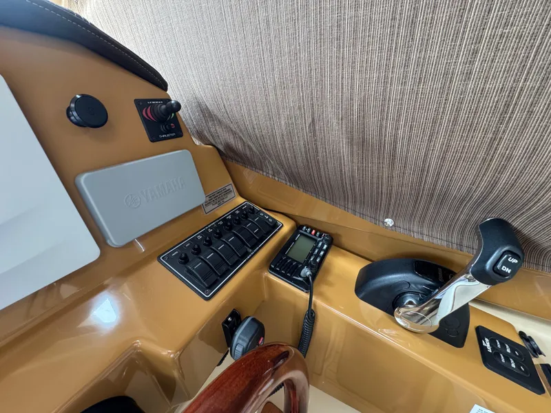 Slide: The Image of 2016 Cutwater C-24 helm with control panel, throttle, and communication device. - 25