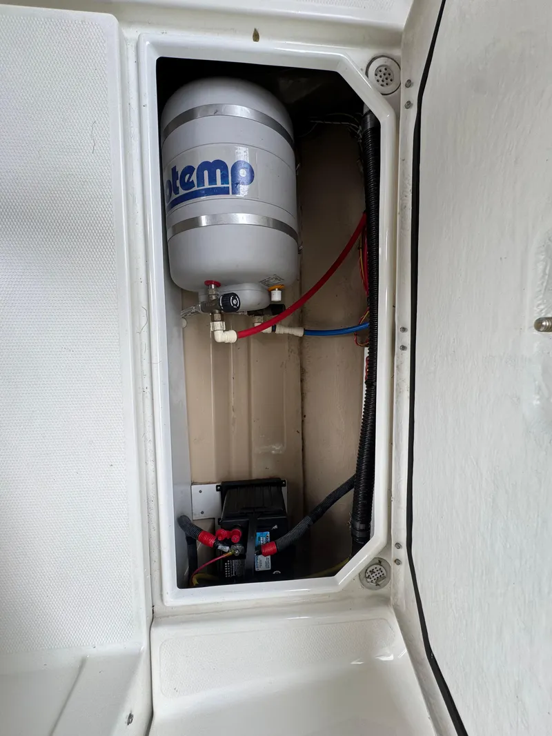 Slide: The Image of 2016 Cutwater C-24 boat compartment with water heater and wiring. - 31