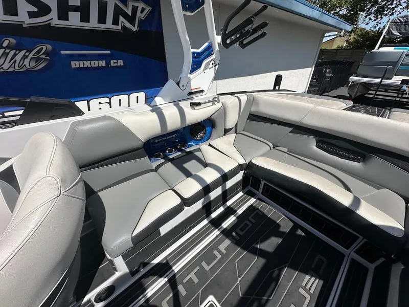 Slide: The Image of Interior of a 2021 Centurion Fi23 boat with gray seating and modern design. - 15