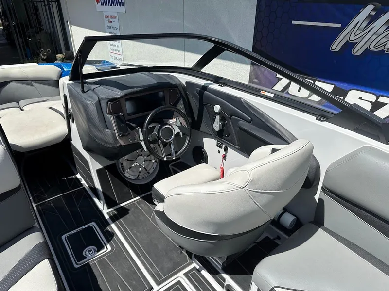 Slide: The Image of 2021 Centurion Fi23 boat interior with sleek dashboard and comfortable seating. - 19