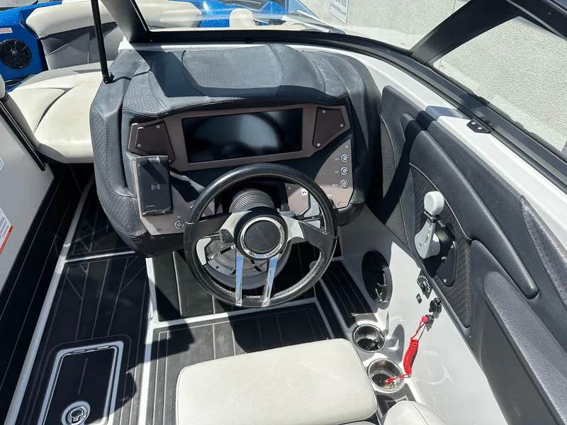 Slide: The Image of 2021 Centurion Fi23 boat interior with steering wheel and control panel. - 20