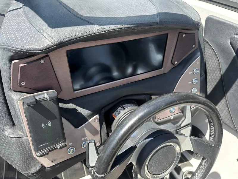 Slide: The Image of Dashboard of a 2021 Centurion Fi23 boat with steering wheel and control panel. - 21