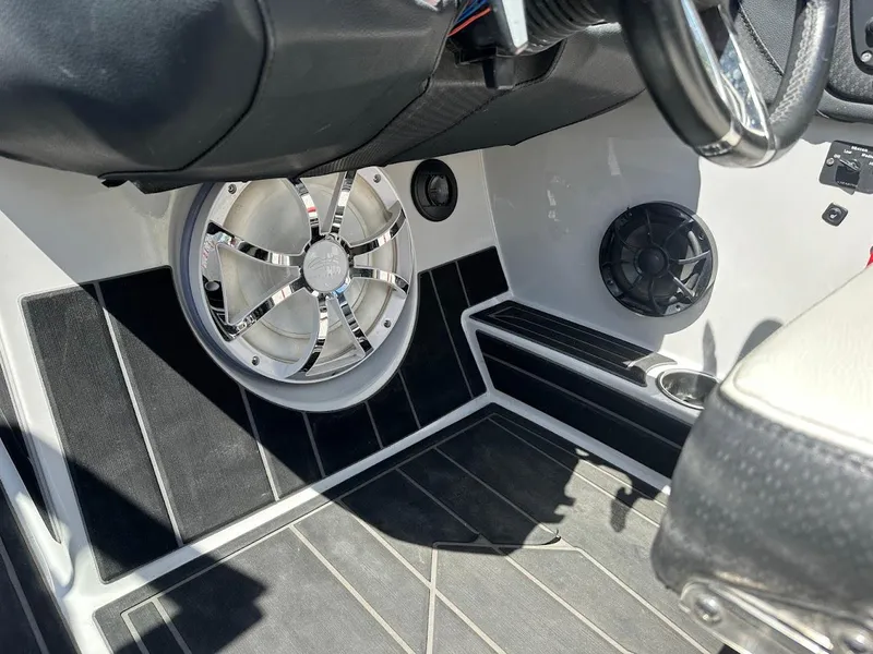 Slide: The Image of 2021 Centurion Fi23 boat interior with premium speakers and sleek black flooring. - 24