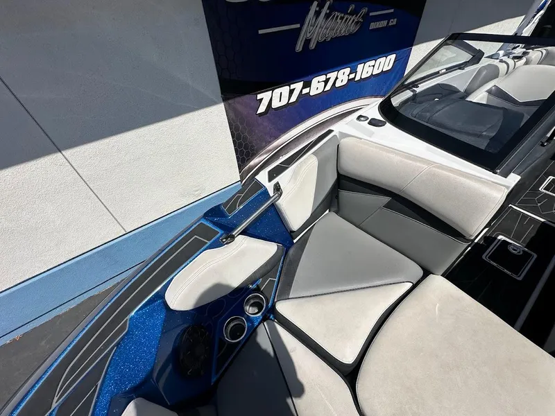 Slide: The Image of 2021 Centurion Fi23 boat interior with blue accents and comfortable seating. - 27