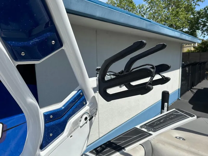 Slide: The Image of 2021 Centurion Fi23 boat with wakeboard rack and blue accents. - 29