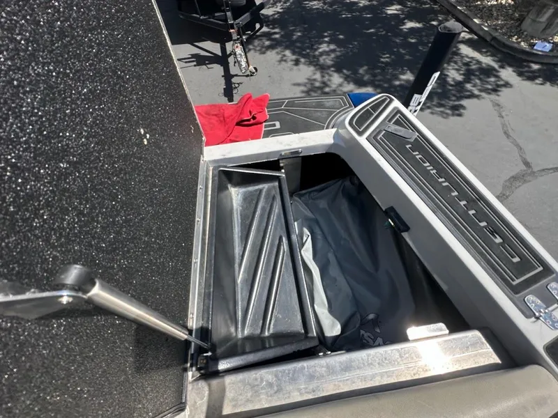 Slide: The Image of 2021 Centurion Fi23 boat storage compartment with open lid and visible interior. - 31