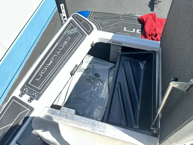 Slide: The Image of 2021 Centurion Fi23 boat storage compartment with branded mat and accessories. - 32