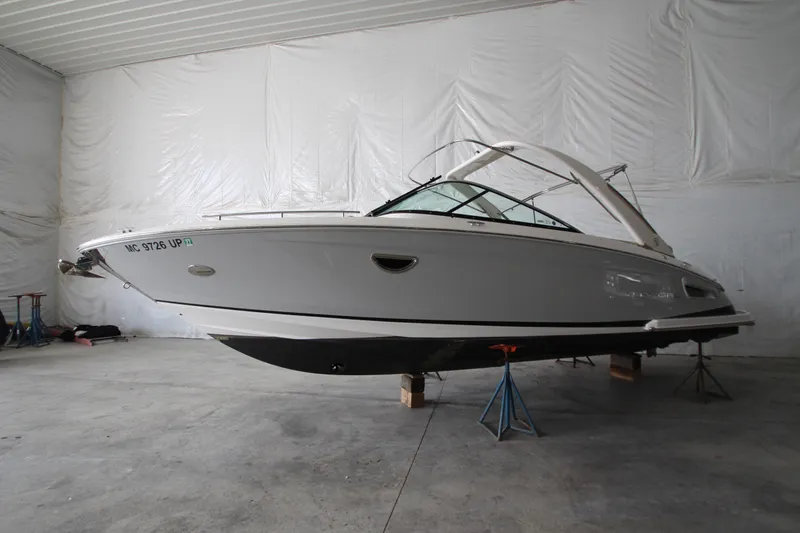 Slide: The Image of 2021 Regal 2800 Bowrider boat in indoor storage on stands. - 0