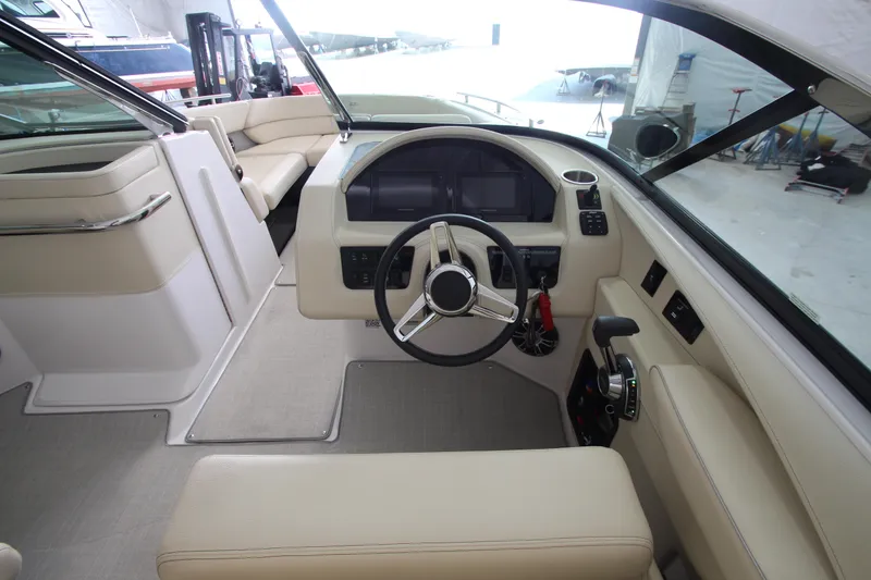 Slide: The Image of 2021 Regal 2800 Bowrider interior with modern helm and beige seating. - 19