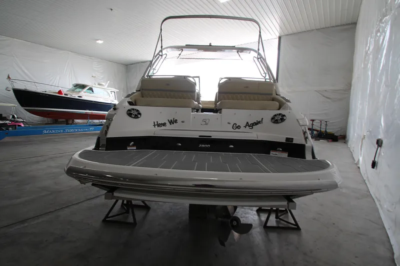 Slide: The Image of 2021 Regal 2800 Bowrider boat in indoor storage, rear view. - 5