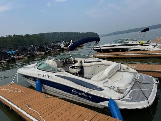 Slide: The Image of 2008 Crownline 240 EX boat docked on a lake with scenic background. - 1
