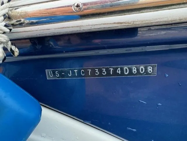 Slide: The Image of 2008 Crownline 240 EX boat hull identification number on blue surface. - 8