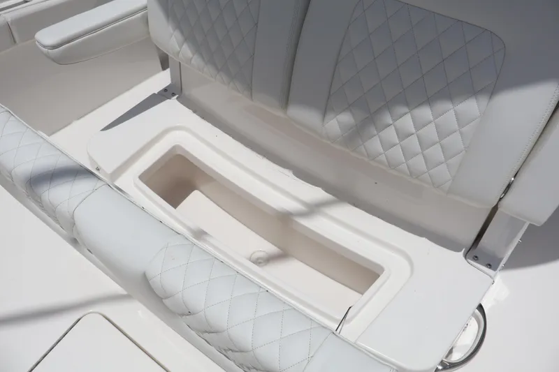 Slide: The Image of 2025 Regulator 26XO boat seat with diamond-stitched upholstery and storage compartment. - 10