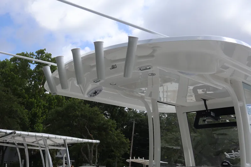 Slide: The Image of 2025 Regulator 26XO boat with rod holders and canopy, set against a cloudy sky. - 11