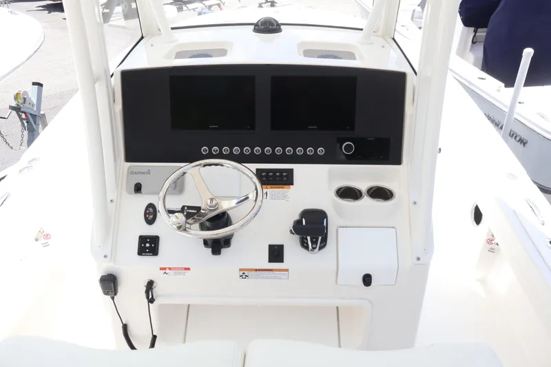 Slide: The Image of 2025 Regulator 26XO boat dashboard with steering wheel and dual screens. - 12