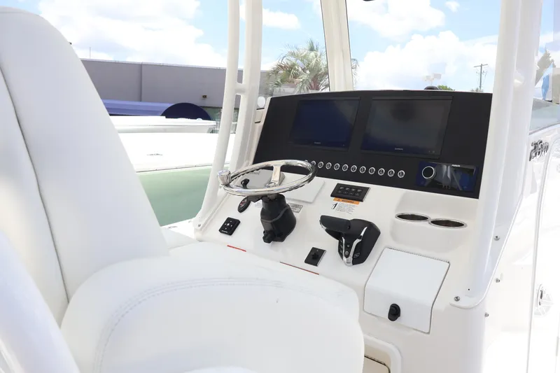 Slide: The Image of 2025 Regulator 26XO boat cockpit with dual screens and steering wheel. - 13