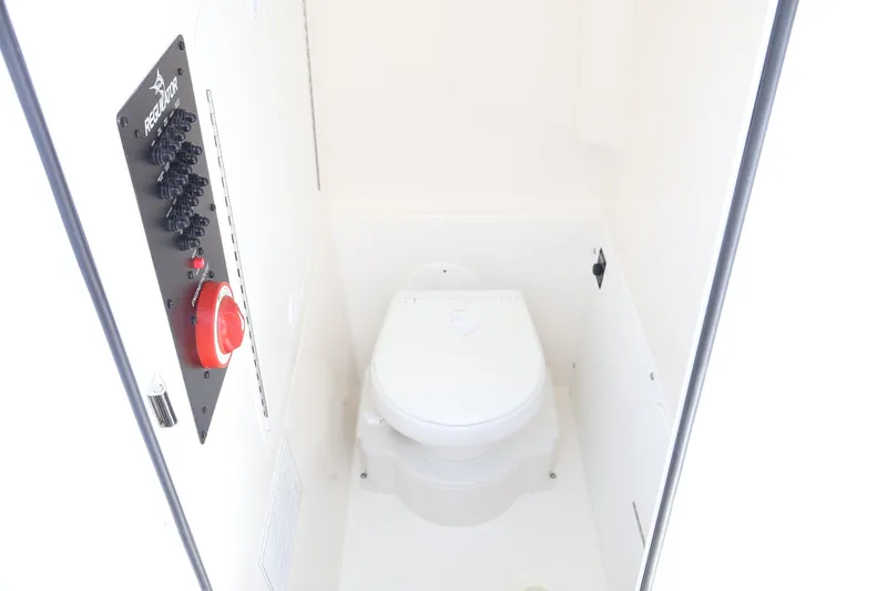 Slide: The Image of 2025 Regulator 26XO boat interior with toilet and control panel. - 16