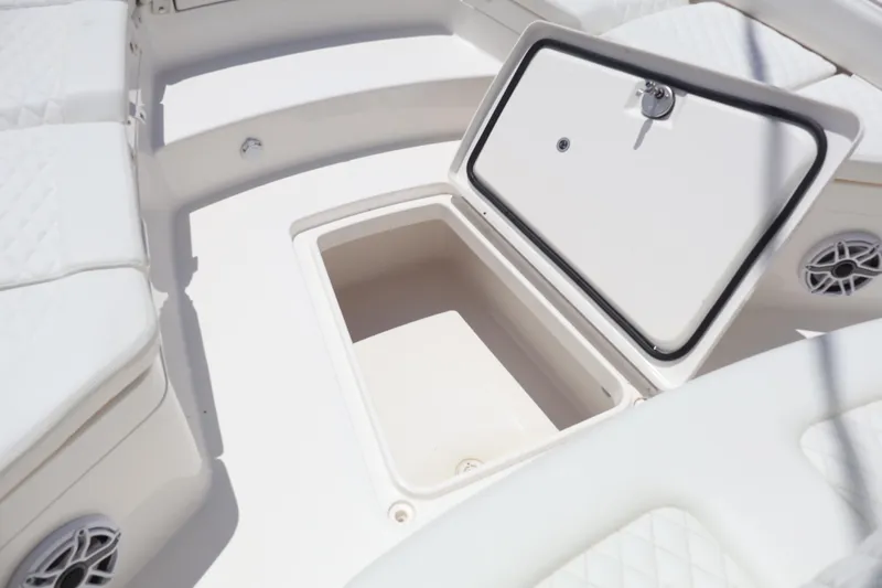 Slide: The Image of 2025 Regulator 26XO boat storage compartment with open hatch, showcasing interior space. - 5
