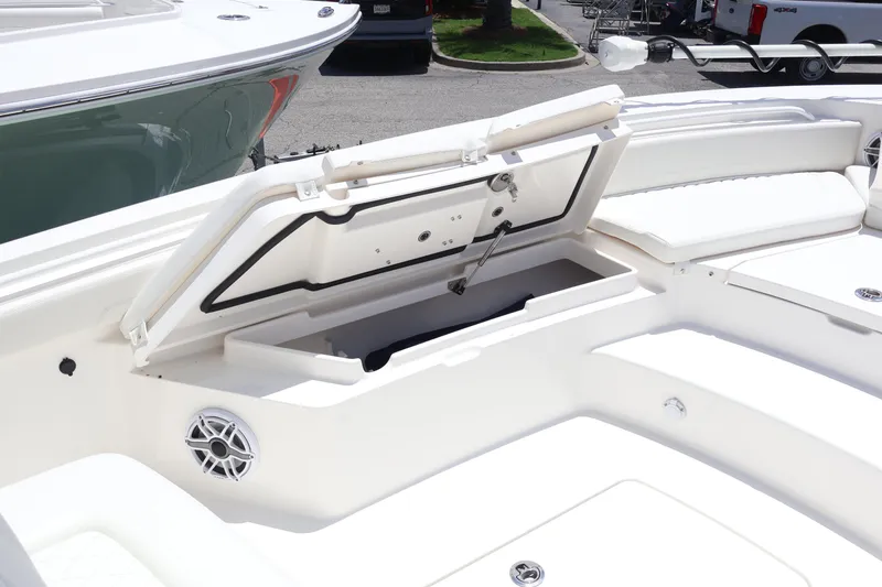 Slide: The Image of 2025 Regulator 26XO boat with open storage compartment and speaker on deck. - 7