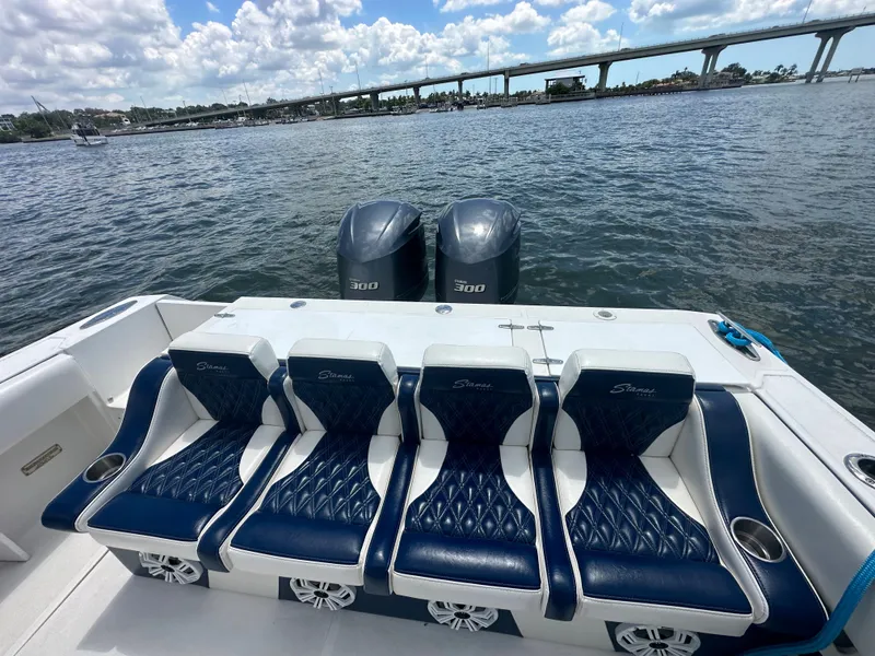 Slide: The Image of 2000 Stamas 290 Tarpon boat with blue seating and twin 300 horsepower engines on the water. - 10